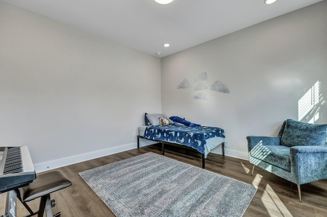 bedroom with baseboards, wood finished floors, and recessed lighting