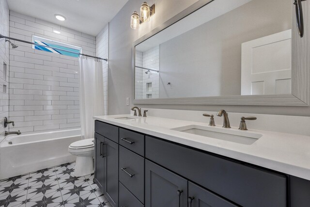 full bath with a sink, shower / bathtub combination with curtain, toilet, and double vanity