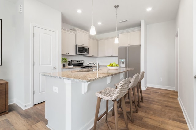 125 Brown Swiss Cir, Summerville, SC 29483 - kitchen with a breakfast bar area, stainless steel appliances, baseboards, and a sink