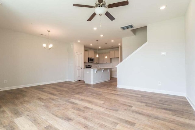 125 Brown Swiss Cir, Summerville, SC 29483 - unfurnished living room with ceiling fan with notable chandelier, visible vents, recessed lighting, baseboards, and light wood-style floors
