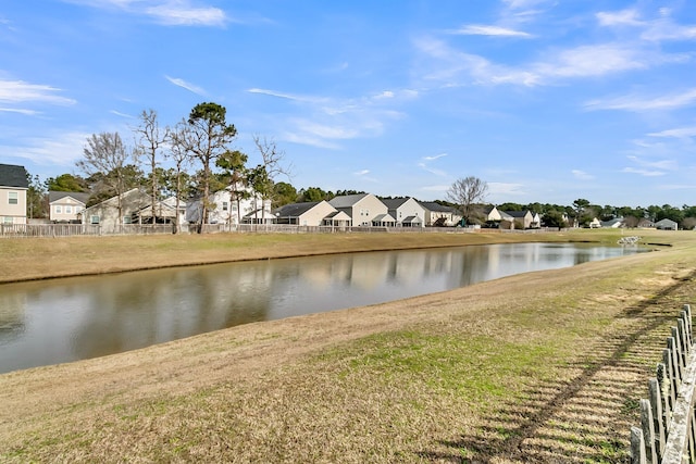 view of water feature with fence and a residential view
