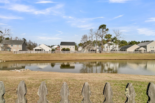 property view of water with fence and a residential view