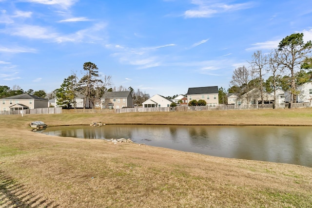 property view of water with fence and a residential view