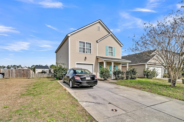 traditional home with concrete driveway, an attached garage, fence, and a front yard