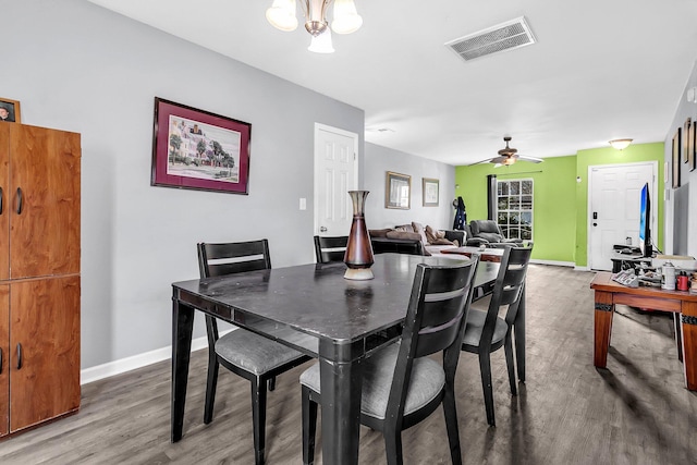 dining room featuring baseboards, wood finished floors, and visible vents