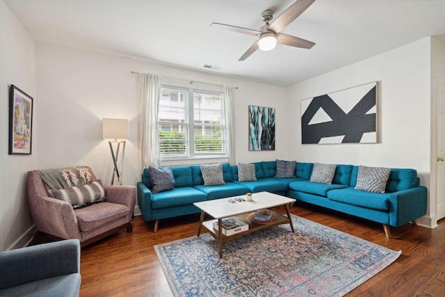 living room featuring visible vents, ceiling fan, and wood finished floors