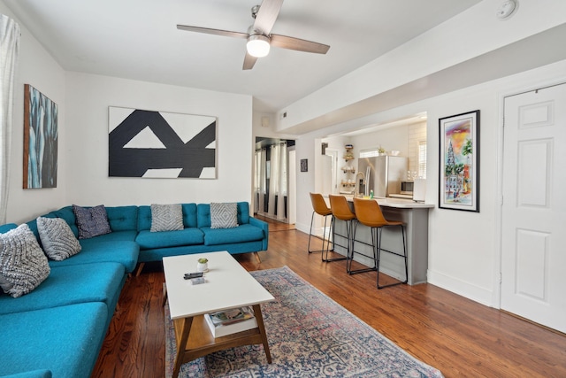 living room featuring dark hardwood / wood-style floors and ceiling fan