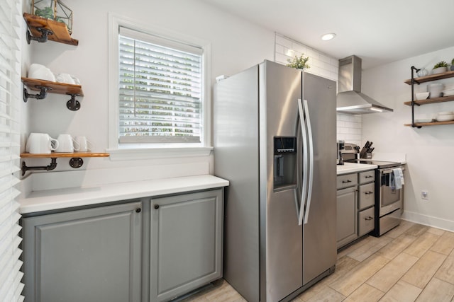 167 Coming St, Charleston, SC 29403 - kitchen featuring stainless steel appliances, wall chimney exhaust hood, open shelves, gray cabinetry, and light countertops