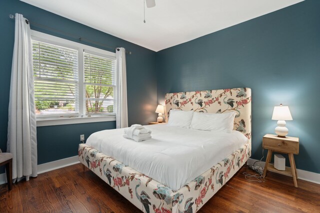 bedroom with multiple windows, a ceiling fan, and dark wood-style flooring