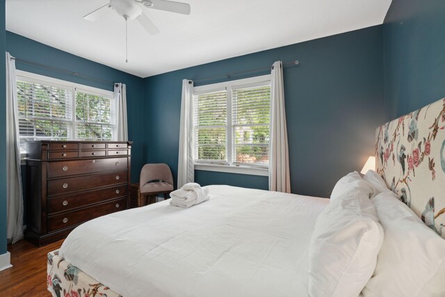 bedroom with ornamental molding, hardwood / wood-style flooring, and ceiling fan