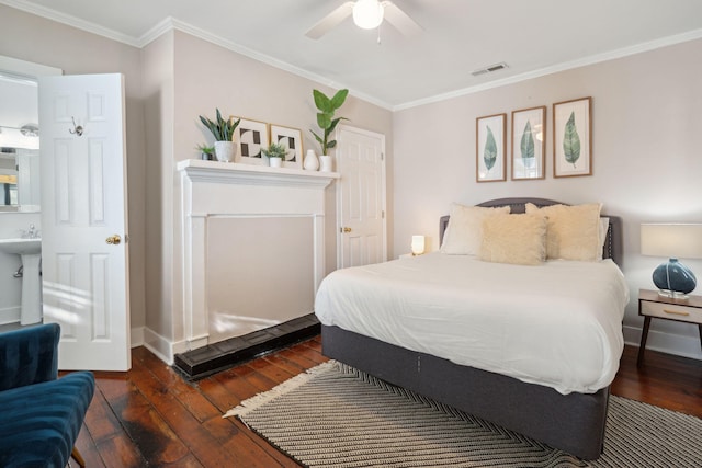 bedroom featuring ornamental molding, ensuite bath, ceiling fan, and dark hardwood / wood-style floors