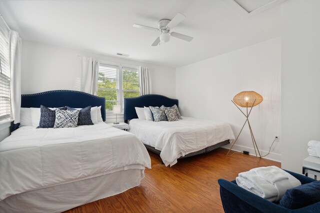 bedroom featuring visible vents, ceiling fan, and dark wood-style flooring