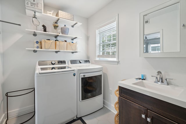 167 Coming St, Charleston, SC 29403 - laundry area featuring independent washer and dryer, cabinet space, light tile patterned floors, and baseboards