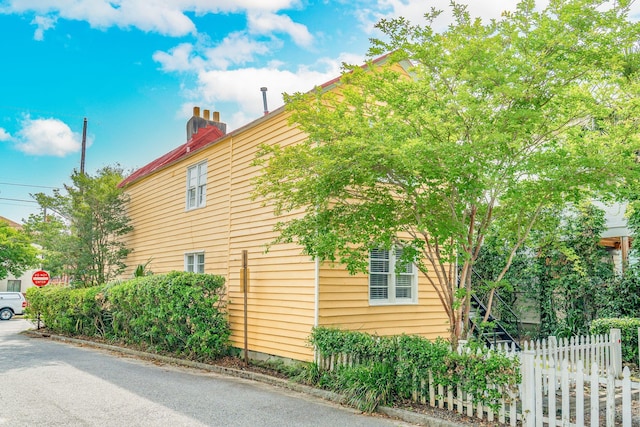 view of property exterior featuring fence