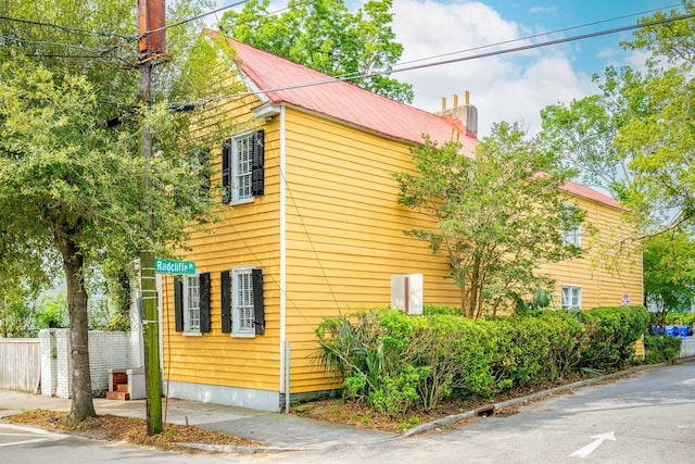 167 Coming St, Charleston, SC 29403 - view of side of property featuring a chimney and metal roof