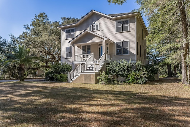 view of front facade featuring a front lawn and a porch