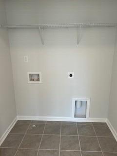 laundry room with hookup for a washing machine, dark tile patterned floors, hookup for an electric dryer, and laundry area