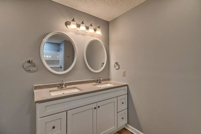 bathroom with vanity and a textured ceiling