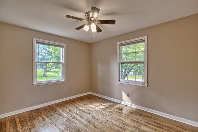 spare room with ceiling fan, plenty of natural light, and light hardwood / wood-style floors