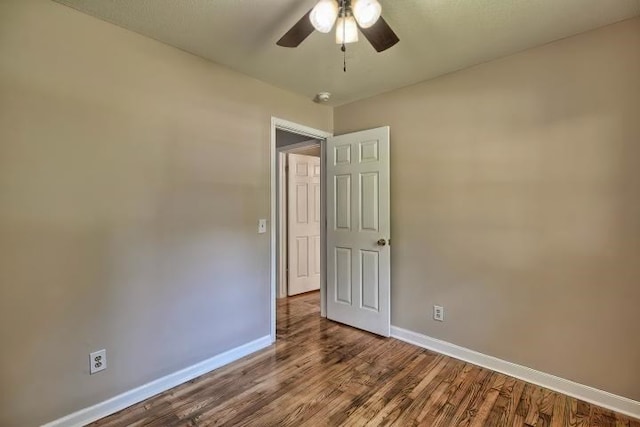 empty room featuring wood-type flooring and ceiling fan