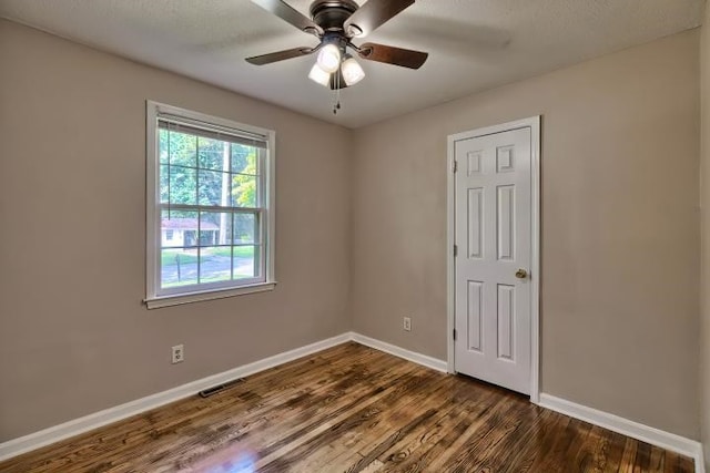 unfurnished room featuring dark hardwood / wood-style floors and ceiling fan