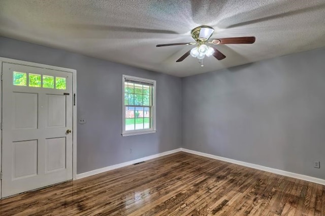 entryway featuring dark hardwood / wood-style flooring, a textured ceiling, and ceiling fan