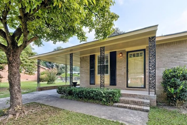 view of exterior entry with a porch