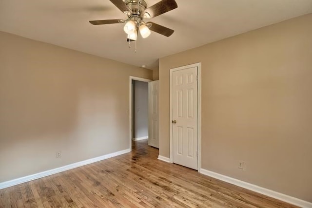 spare room with light wood-type flooring and ceiling fan