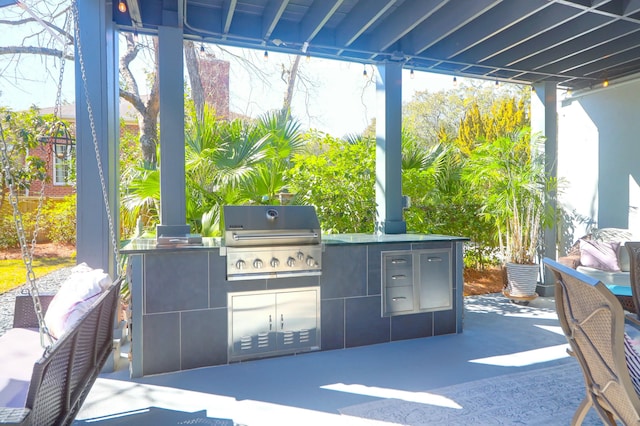 view of patio / terrace with an outdoor kitchen and a grill