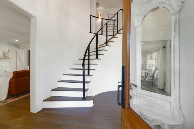 staircase featuring wood finished floors