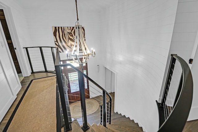 stairs with an inviting chandelier