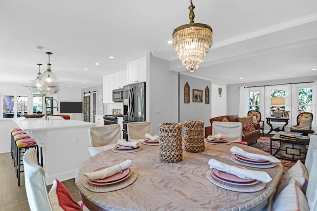 dining area with light wood-style floors, a wealth of natural light, and recessed lighting