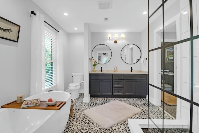 full bath featuring double vanity, visible vents, toilet, tile patterned flooring, and a freestanding bath