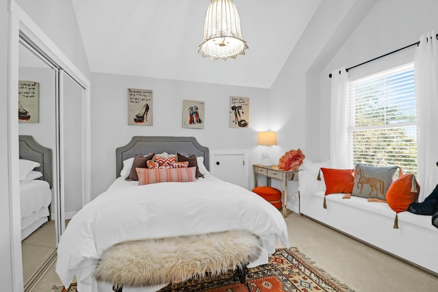 bedroom featuring lofted ceiling, carpet, and a closet