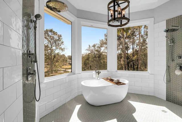 bathroom featuring a healthy amount of sunlight, a soaking tub, tiled shower, and tile patterned floors