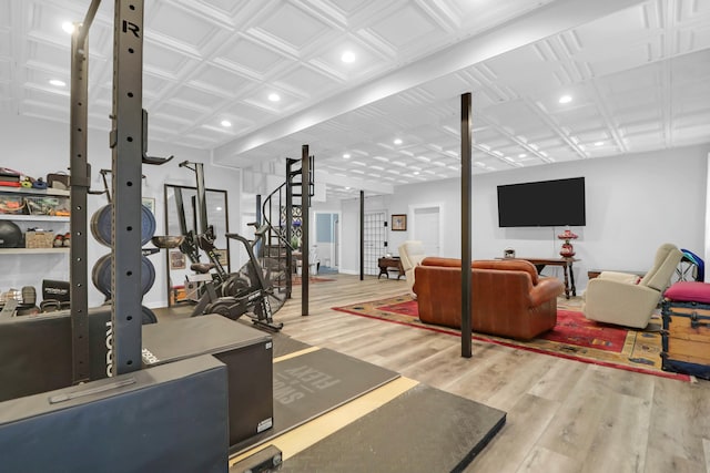 exercise room featuring an ornate ceiling, baseboards, wood finished floors, and recessed lighting