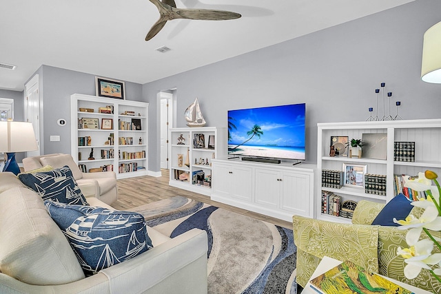 living room featuring ceiling fan and light hardwood / wood-style flooring