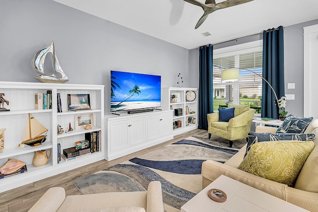 living room with hardwood / wood-style floors and ceiling fan