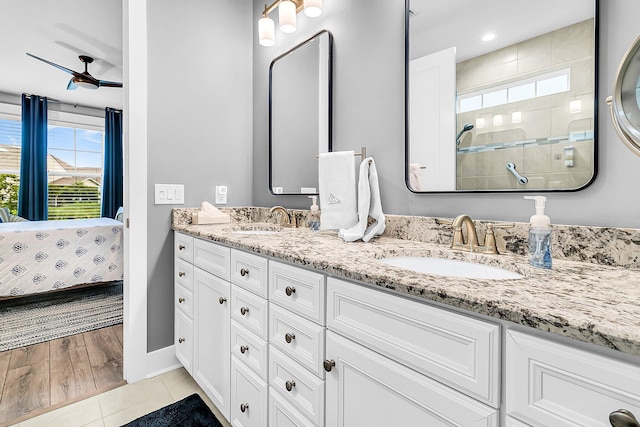 bathroom with tile patterned flooring, vanity, and ceiling fan