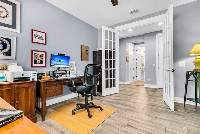 home office featuring light wood-type flooring and french doors