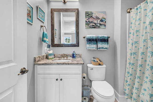 bathroom with vanity, walk in shower, and toilet