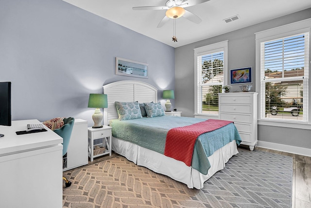 bedroom with hardwood / wood-style flooring and ceiling fan