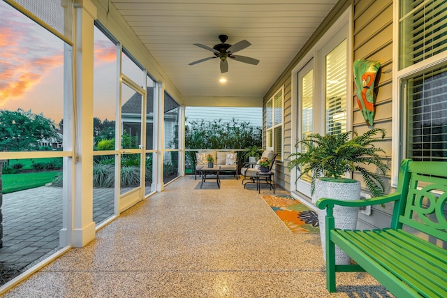 unfurnished sunroom with ceiling fan