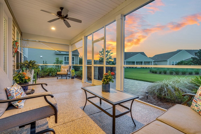 sunroom / solarium featuring ceiling fan