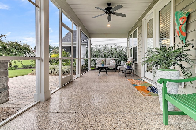 unfurnished sunroom with ceiling fan