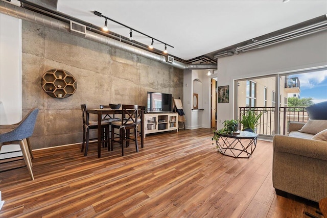 living room with hardwood / wood-style flooring and track lighting