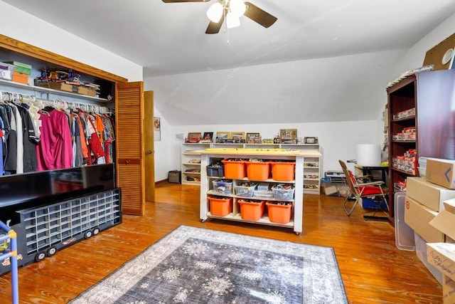 interior space featuring lofted ceiling, a closet, wood finished floors, and a ceiling fan