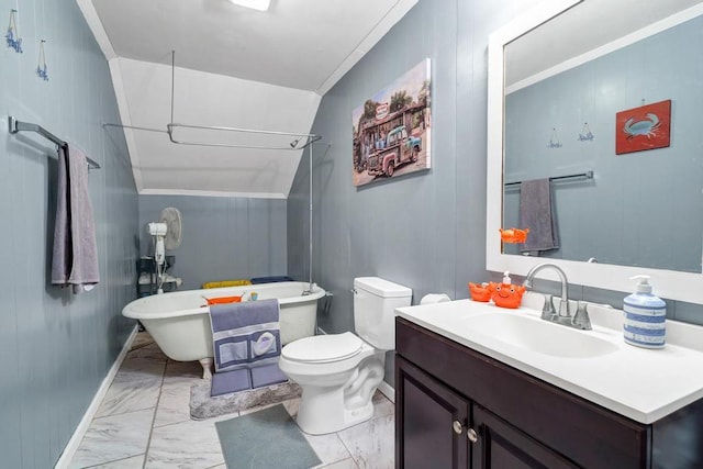 full bathroom featuring a freestanding tub, toilet, vanity, baseboards, and marble finish floor