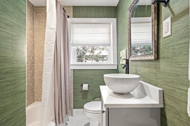 full bathroom with vanity, shower / bathtub combination with curtain, tile patterned flooring, tile walls, and toilet