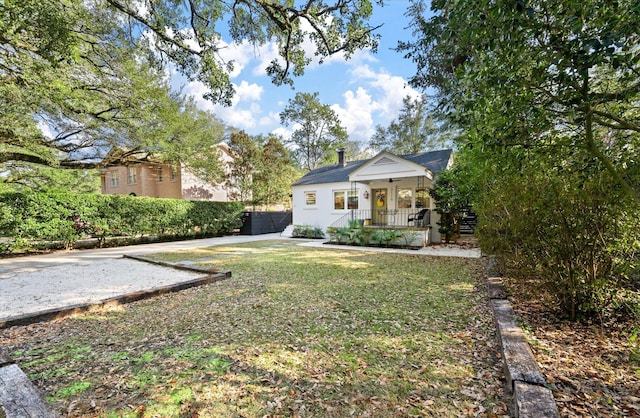 view of yard featuring covered porch